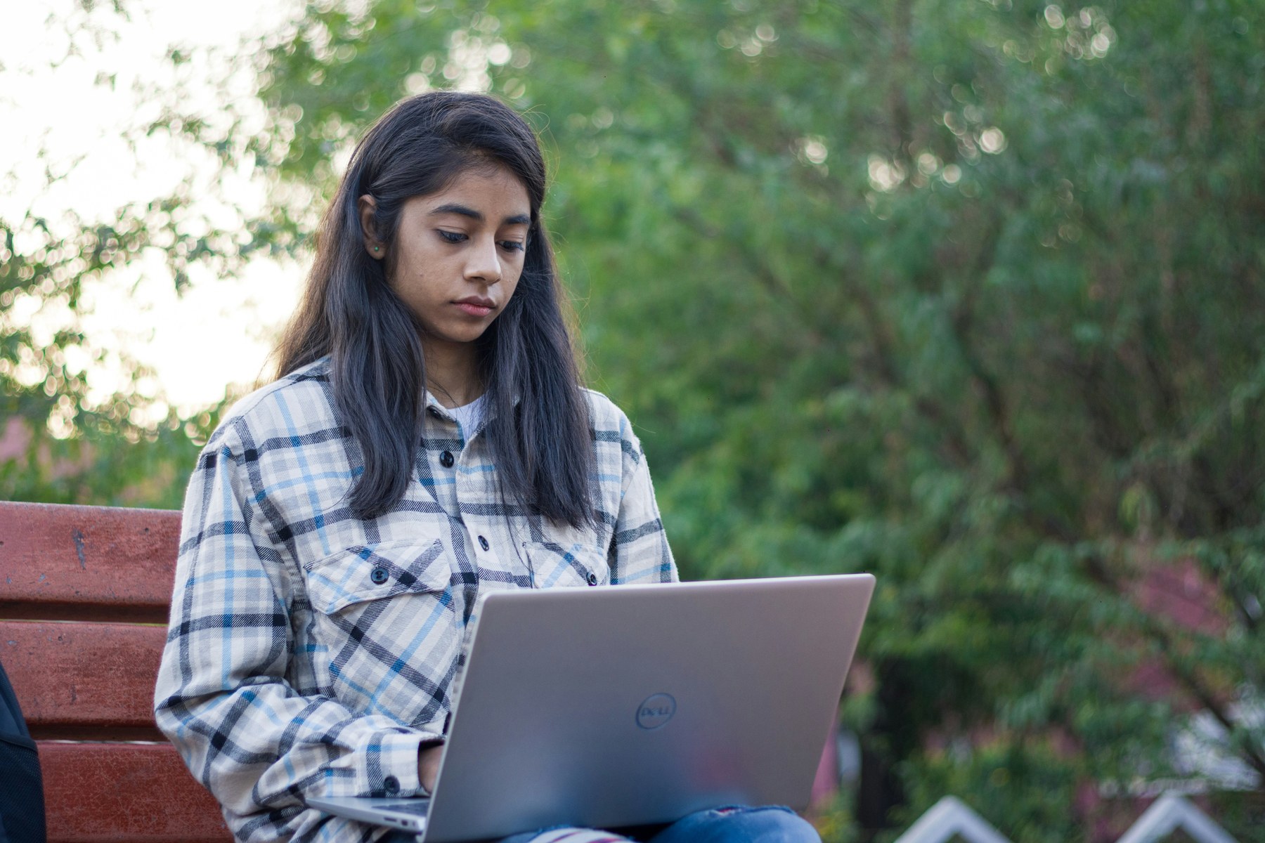 Indian student working on a laptop in an academic setting